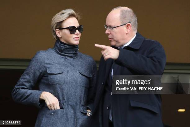 Princess Charlene of Monaco speaks with Prince Albert II of Monaco as they attend the International Rugby tournament Tournoi Sainte Devote at the...