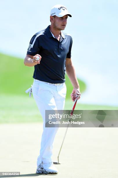 Emiliano Grillo of Argentina acknowledges the crowd after making par on the 18th green during the third round of the Houston Open at the Golf Club of...