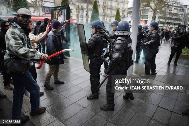 Protesters face riot policemen while members of associations, unions and collectives, supporting migrants but also occupants of the ZAD of...