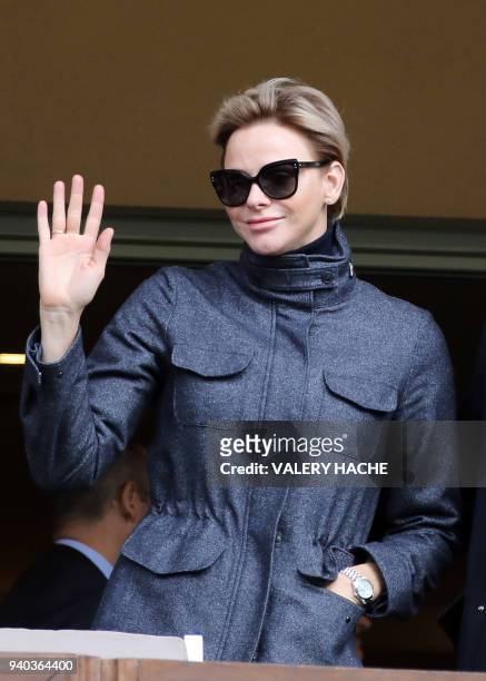 Princess Charlene of Monaco waves as she attends the International Rugby tournament Tournoi Sainte Devote at the Louis II Stadium in Monaco on March...