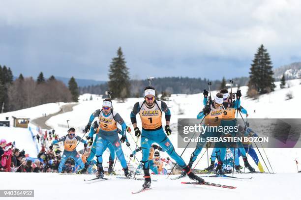 France's Simon Desthieux, Martin Fourcade and Antonin Guigonnat compete during the mass start Premanon French Biathlon Championships on March 31,...