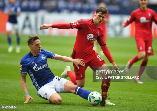 Freiburg's German defender Pascal Stenzel and Schalke's German defender Bastian Oczipka vie for the ball during the German first division Bundesliga...