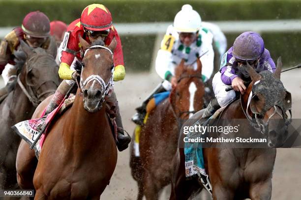 Audible, riden by John Valesquez, battles Catholic Boy, riden by Irad Ortiz Jr, out of turn four during the Florida Derby at Gulfstream Park on March...