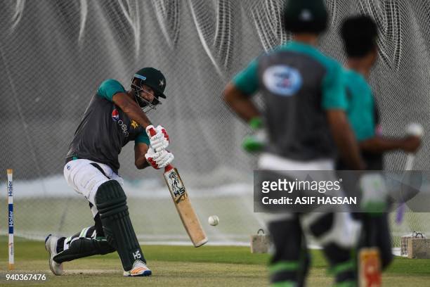 Pakistan cricketer Hussain Talat plays a shot during a team practice at the National Cricket Stadium in Karachi on March 31, 2018 on the eve of the...