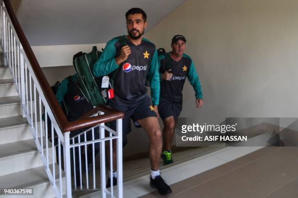 Pakistan bowler Mohammad Amir arrives for a team practice at the National Cricket Stadium in Karachi on March 31, 2018 on the eve of the team's three...
