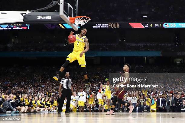 Charles Matthews of the Michigan Wolverines dunks in the second half against the Loyola Ramblers in the 2018 NCAA Men's Final Four semifinal game at...