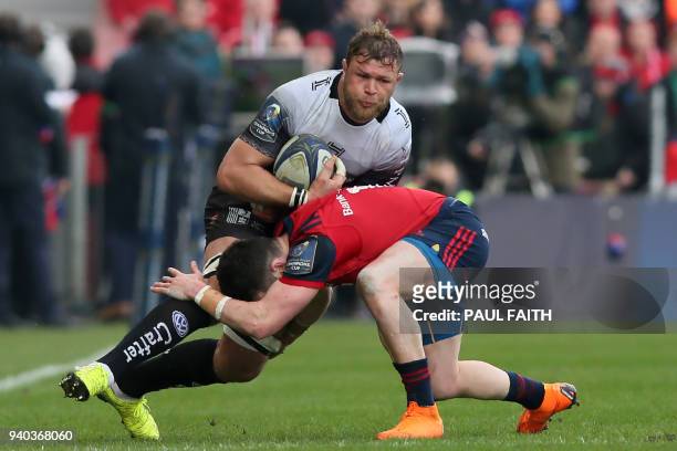 Toulon's South African number 8 Duane Vermeulen is tackled during the European Champions Cup quarter-final rugby union match between Munster and...