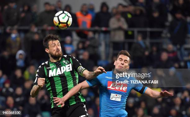 Napoli's Polish striker Arkadiusz Milik fights for the ball with Sassuolo's defender Francesco Acerbi during the Italian Serie A football match...