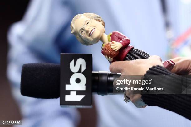 Personality Tracy Wolfson holds a bobblehead of Loyola Ramblers team chaplain Sister Jean Dolores-Schmidt in the first half against the Michigan...