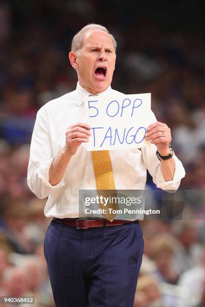 Head coach John Beilein of the Michigan Wolverines holds up a sign in the first half against the Loyola Ramblers during the 2018 NCAA Men's Final...