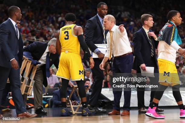 Head coach John Beilein of the Michigan Wolverines speaks to Zavier Simpson in the second half against the Loyola Ramblers during the 2018 NCAA Men's...