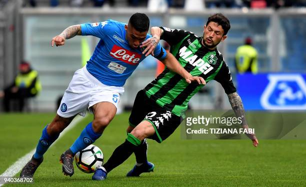 Napoli's Brazilian midfielder Marques Loureiro Allan fights for the ball with Sassuolo's midfielder Stefano Sensi during the Italian Serie A football...