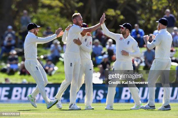 Stuart Broad of England is congratulated by team mates after claiming his 5th wicket during day three of the Second Test match between New Zealand...