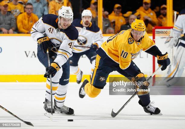 Justin Falk of the Buffalo Sabres skates against Colton Sissons of the Nashville Predators during an NHL game at Bridgestone Arena on March 31, 2018...