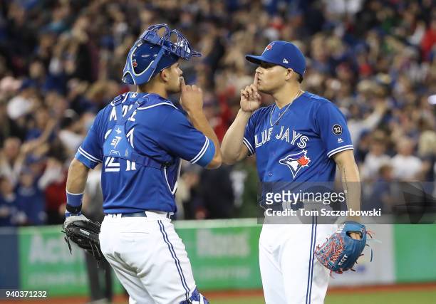 Roberto Osuna of the Toronto Blue Jays celebrates their victory with Luke Maile during MLB game action against the New York Yankees at Rogers Centre...