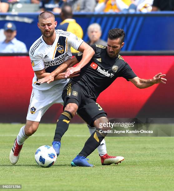 Perry Kitchen of Los Angeles Galaxy and Steven Beitashour of Los Angeles FC battle for the ball in the second half of the game as at StubHub Center...