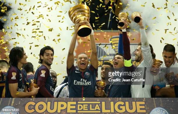 Kylian Mbappe of PSG holds the trophy and celebrates the victory between Edinson Cavani, Javier Pastore, Thiago Silva, Kevin Trapp following the...