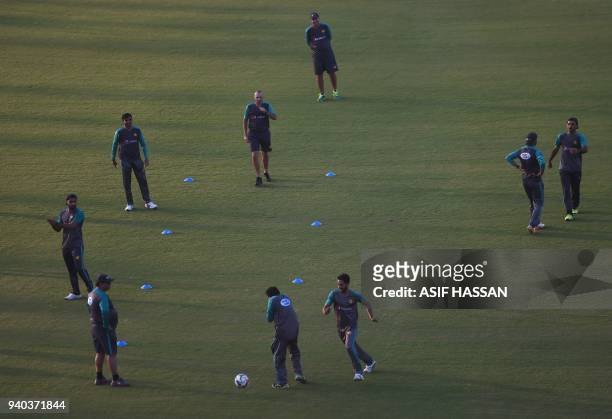 Members of Pakistan's cricket team play football during a team practice at the National Cricket Stadium in Karachi on March 31 on the eve of their...