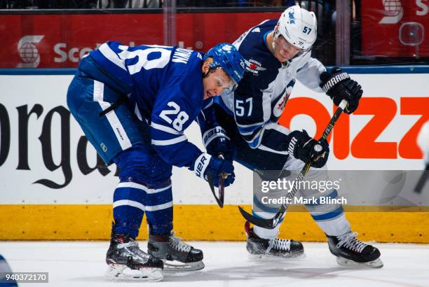 Connor Brown of the Toronto Maple Leafs skates against Tyler Myers of the Winnipeg Jets during the first period at the Air Canada Centre on March 31,...