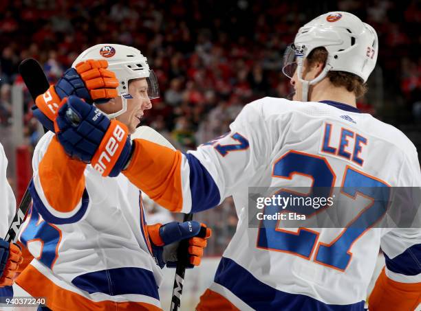 Tanner Fritz of the New York Islanders is congratulated by teammate Anders Lee after Fritz scored in the first peirod against the New Jersey Devils...