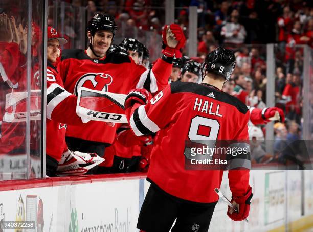 Taylor Hall of the New Jersey Devils celebrates his goal with teammates on the bench in the second period against the New York Islanders on March 31,...