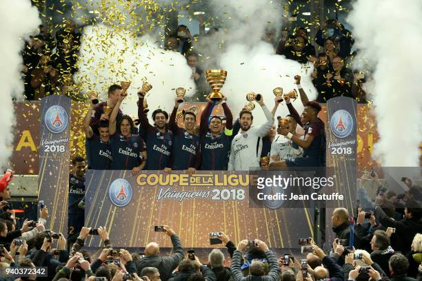 Captain Thiago Silva holding the trophy and teammates of PSG celebrate the victory following the French League Cup final between Paris Saint-Germain...