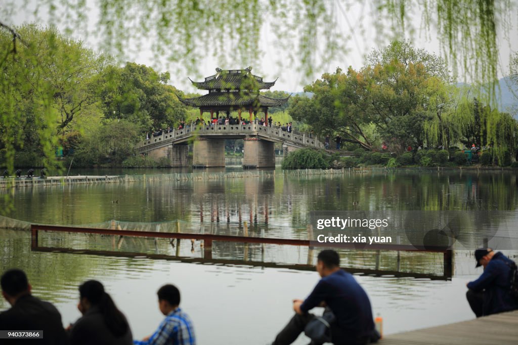 Tourists sitting side of the West Lake,Hangzhou,China