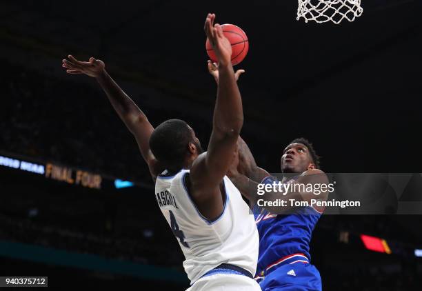 Silvio De Sousa of the Kansas Jayhawks drives to the basket against Eric Paschall of the Villanova Wildcats in the first half during the 2018 NCAA...