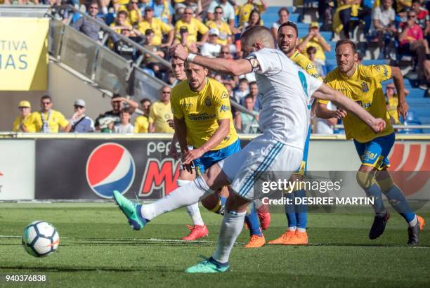 Real Madrid's French forward Karim Benzema shoots to score a goal during the Spanish League football match between UD Las Palmas and Real Madrid CF...