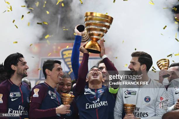 Paris Saint-Germain's Brazilian defender Thiago Silva holds the trophy as he celebrates with teammates German goalkeeper Kevin Trapp , Argentinian...