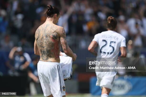 Zlatan Ibrahimovic of Los Angeles Galaxy celebrates after scoring a goal to make it 3-3 by taking his shirt off to reveal his tattoos during the MLS...