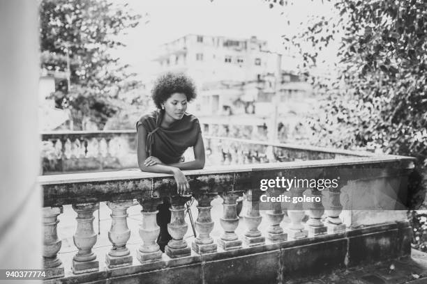 beautiful afro-caribbean cuban woman on balcony in havanna - afro caribbean portrait stock pictures, royalty-free photos & images