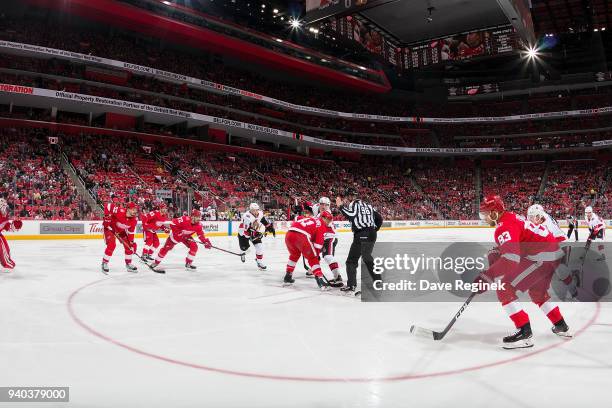 Luke Glendening of the Detroit Red Wings faces off against Matt Duchene of the Ottawa Senators during an NHL game at Little Caesars Arena on March...