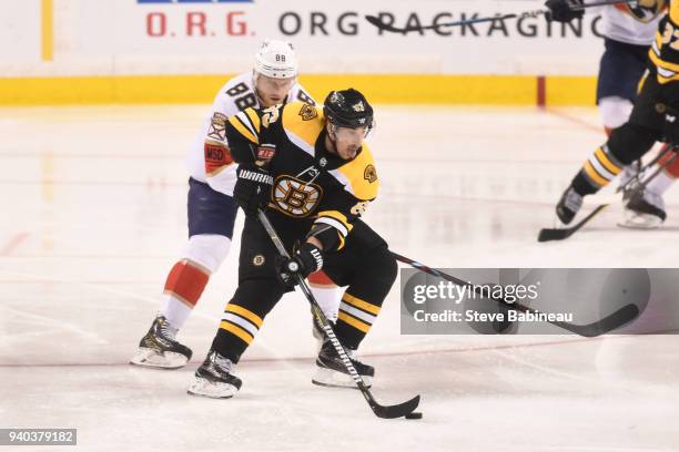 Brad Marchand of the Boston Bruins skates with the puck against Jamie McGinn of the Florida Panthers at the TD Garden on March 31, 2018 in Boston,...