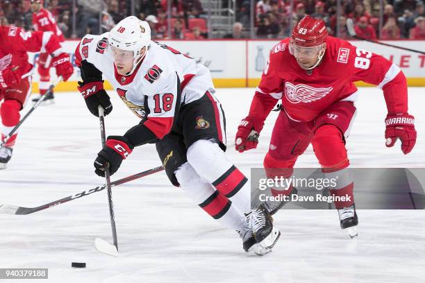 Ryan Dzingel of the Ottawa Senators skates up ice with the puck followed by Trevor Daley of the Detroit Red Wings during an NHL game at Little...