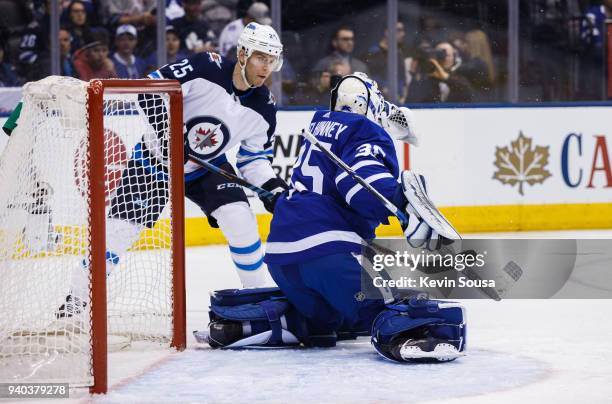 Curtis McElhinney of the Toronto Maple Leafs makes a save on Paul Stastny of the Winnipeg Jets during the first period at the Air Canada Centre on...