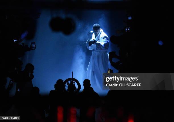 And WBA world heavyweight champion Anthony Joshua of Great Britain enters the ring for his unification bout against New Zealand's WBO champion Joseph...