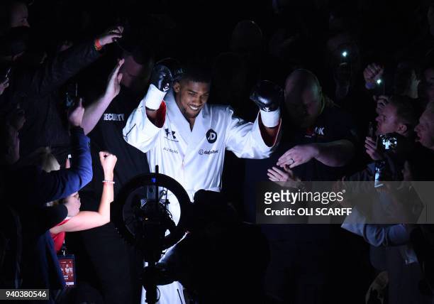 And WBA world heavyweight champion Anthony Joshua of Great Britain enters the ring for his unification bout against New Zealand's WBO champion Joseph...