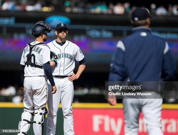 James Paxton of the Seattle Mariners reacts as Seattle Mariners manager Scott Servais walks to the mound to take him out of the game in the fifth...