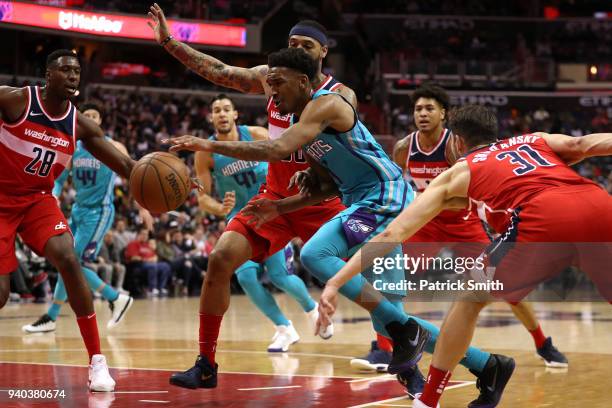 Malik Monk of the Charlotte Hornets dribbles in front of Ian Mahinmi of the Washington Wizards during the second half at Capital One Arena on March...