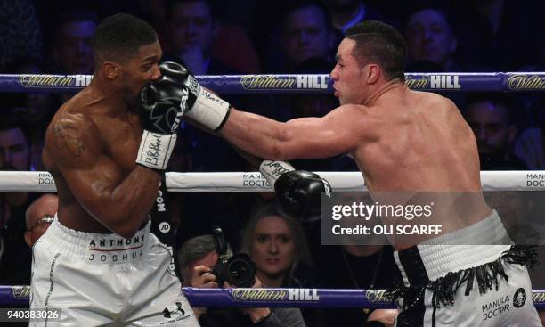 Joseph Parker of New Zealand connects with a left against Anthony Joshua of Great Britain during their heavyweight unification bout at Principality...