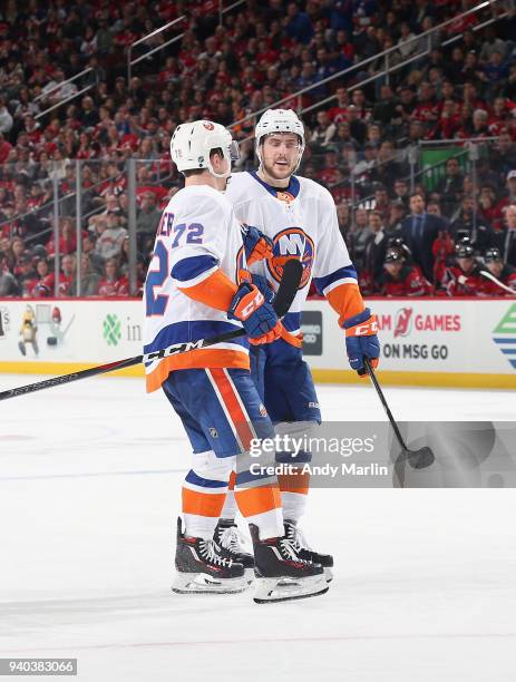 Anthony Beauvillier of the New York Islanders is congratulated by Ryan Pulock after scoring a second-period goal against the New Jersey Devils during...