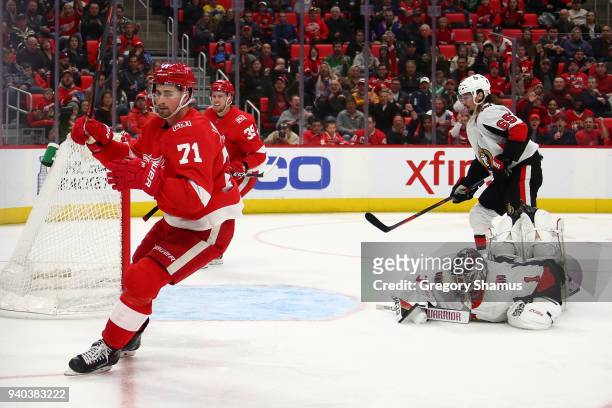 Dylan Larkin of the Detroit Red Wings celebrates his second period goal in front of Mike Condon of the Ottawa Senators at Little Caesars Arena on...