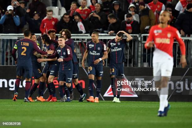 Paris Saint-Germain's Uruguayan forward Edinson Cavani is congratulated by teammates after scoring a penalty during the French League Cup final...