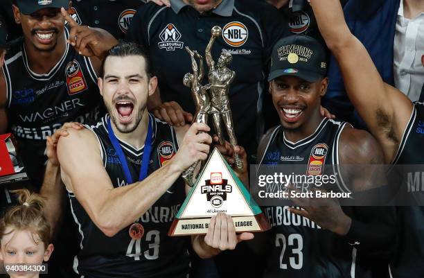 Melbourne United captain Chris Goulding, Casey Prather of Melbourne United and their teammates celebrate as they are presented with the trophy after...