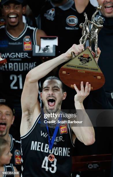 Melbourne United captain Chris Goulding celebrates as they are presented with the trophy after winning game five of the NBL Grand Final series...