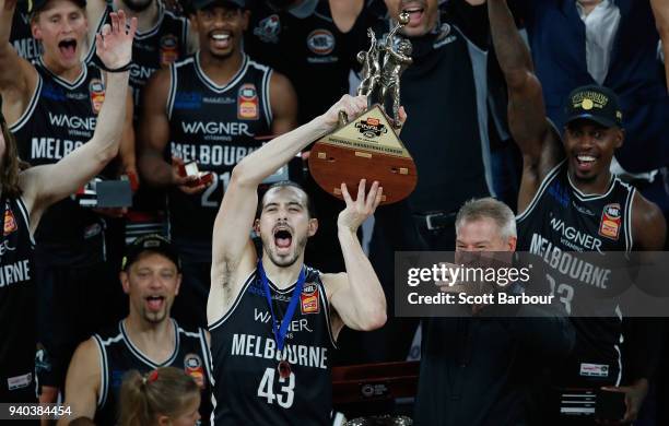 Melbourne United captain Chris Goulding and coach Dean Vickerman celebrate as they are presented with the trophy after winning game five of the NBL...