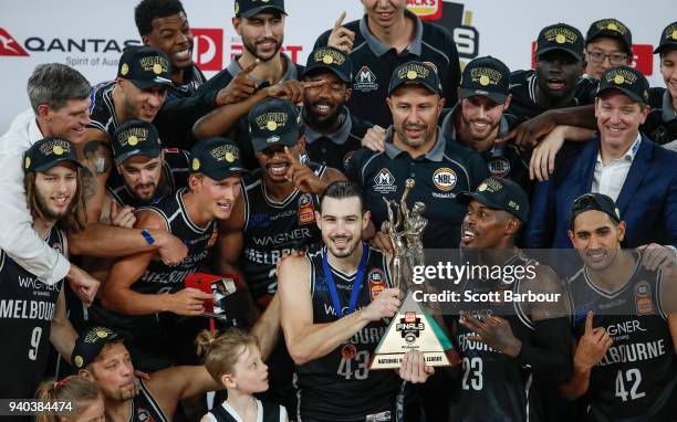 Melbourne United captain Chris Goulding, Casey Prather of Melbourne United and their teammates celebrate as they are presented with the trophy after...