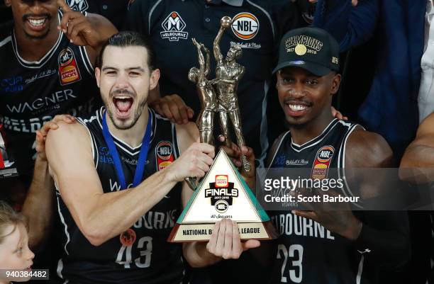 Melbourne United captain Chris Goulding, Casey Prather of Melbourne United and their teammates celebrate as they are presented with the trophy after...