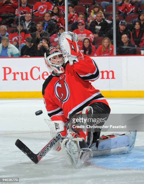 Martin Brodeur of the New Jersey Devils stops a shot on goal during the shoot out against the Detroit Red Wings on December 5, 2009 at the Prudential...
